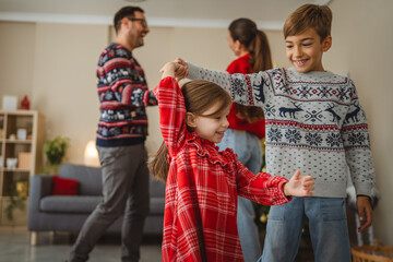 Happy children dancing with parents at christmas time