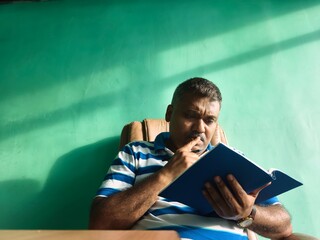 Middle aged man making plan inside house
