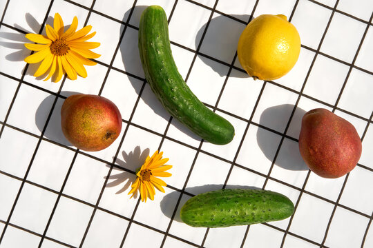 Fresh Fruits and Vegetables on a checkered background under sunlight.