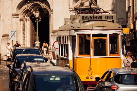 Iconic yellow tram and historic architecture in Lisbon