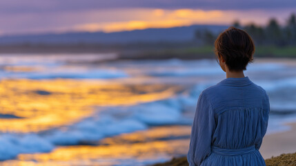 Fototapeta premium Lonely woman on a quiet beach at sunset, golden rays painting the sea and sky, her silhouette framed against the fading light, capturing the bittersweet mood of vacation solitude