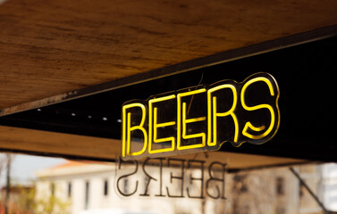 Neon beer sign glowing in Lisbon's Intendente area
