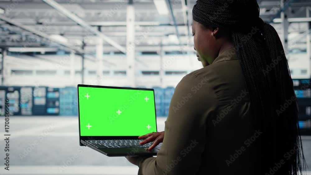 Poster computer scientist at work using green screen laptop in data center to check hardware for system sta