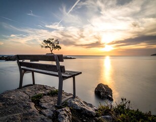 Empty bench at sunset over calm sea