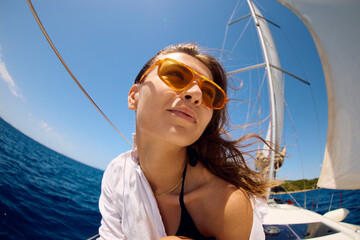 Beautiful woman travels in the open sea