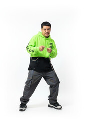 Naklejka premium Energetic man in neon green hoodie and street style outfit clenches a chain with a determined expression, symbolizing strength and urban fashion.