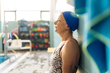 Senior woman relaxing after swimming in indoor pool
