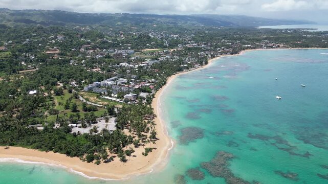 Aerial drone view of Punta Popy Beach &mdash; palm-lined shore with blue Caribbean waters. Great for eco-tourism and resorts