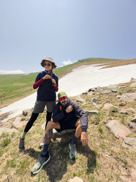 Couple in mountains by the patch of snow
