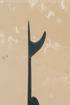 Surfboard Fin Shadow on Sand