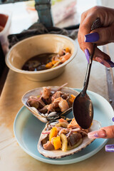 Eating clam served in the shell