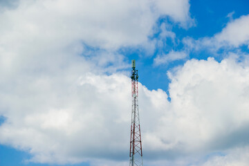 Cell Tower Against Blue Sky and Clouds