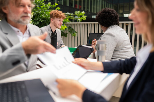 Business Team Collaborating on a Project in Urban Setting