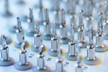 Selective focus of dental implant drill bit in surgical tray, professional dentistry equipment