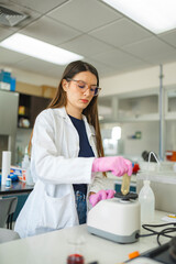 Scientist using vortex mixer in laboratory