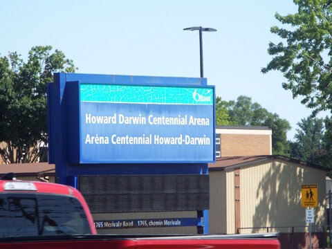 Nepean, ON, Canada, June 18, 2025: A large blue sign for the "Howard Darwin Centennial Arena" at 1765 Merivale Rd.
