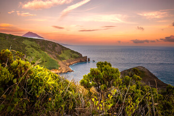 Beautiful sunset over the ocean with a mountain in the background © isabella