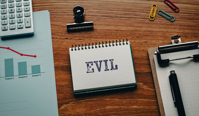 There is notebook with the word EVIL. It is as an eye-catching image.