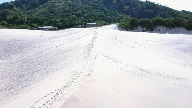 Aerial view of the dunes of Joaquina Beach in Florian&oacute;polis, Santa Catarina. People surfing on the sand, sandboard, sports, dune fields, restinga vegetation, ecological and tourist lagoons