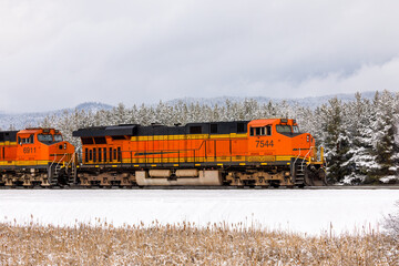 powerful freight train pulling cargo on a frigid winter day close to Whitefish, Montana