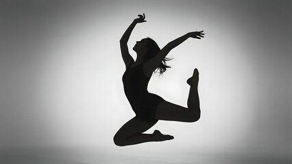 Silhouette of a dancer mid-jump against a gradient background