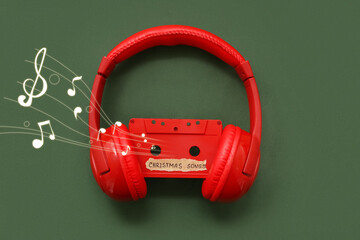 Audio cassette with headphones on green background