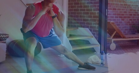 Athlete performing side lunge in home gym, with foam roller water bottle towel watch lounge chair