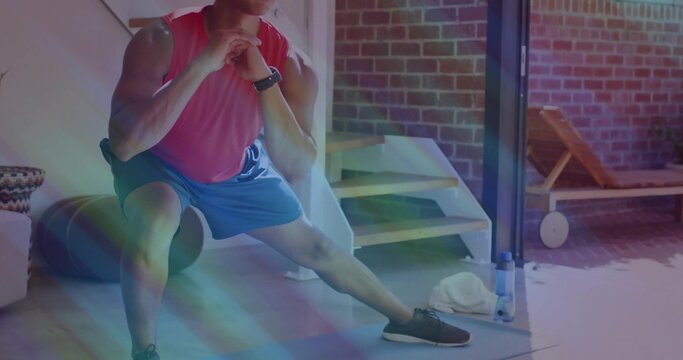 Fototapeta Athlete performing side lunge in home gym, with foam roller water bottle towel watch lounge chair