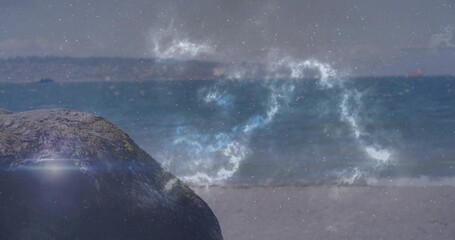 Resting large dark boulder on sandy shoreline, ocean waves under glowing cosmic nebula, copy space
