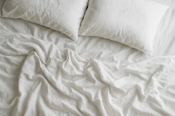 Obraz premium Sunlit rumpled linen bed with soft shadows minimal airy bedroom top down view monochrome white texture background for mockups and design