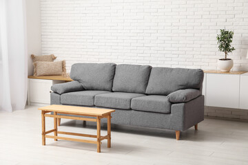 Cozy sofa with coffee table in interior of living room