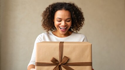 A joyful woman excitedly unwrapping a gift, showcasing a moment of happiness and surprise.