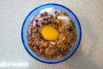 Top view, Shaved ice with egg yolk in blue bowl.