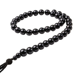 Obraz premium Black Prayer Beads With Tassel On Black Background rosary mala
