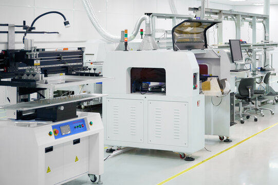 SMT placement machine in a modern electronic manufacturing facility during daytime operations