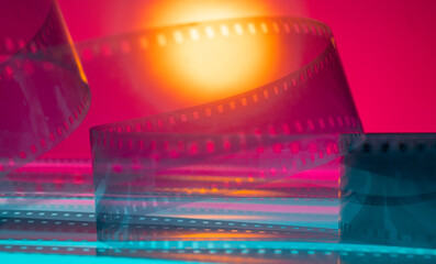 Cinematic orange pink and blue abstract background with film strip