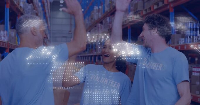 Volunteer team raising hands then high-fiving in logistics hub with confetti celebrating teamwork