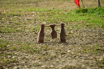 wooden bottle for petanque sport Thai style, equipment on green grass