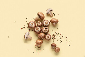 Fresh raw mushrooms and peppercorns on yellow background
