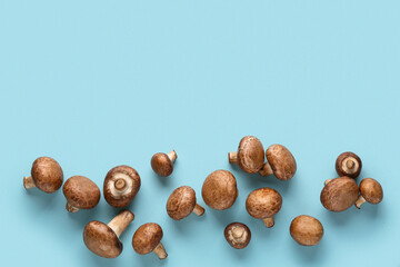 Fresh raw mushrooms on blue background