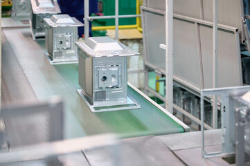 Microwave oven casings on assembly line in manufacturing facility during production process