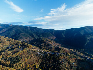 Obraz premium Aerial view of Tara mountains in Serbia with autumn forest, rural valley and morning mist. g.