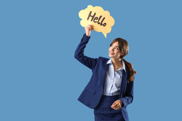 Young businesswoman holding speech bubble with word HELLO on blue background