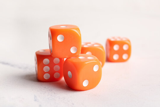 Orange dices on light background