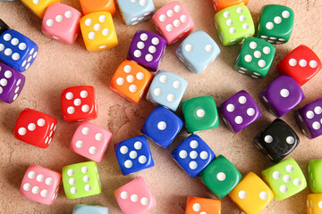 Many colorful dices on beige background