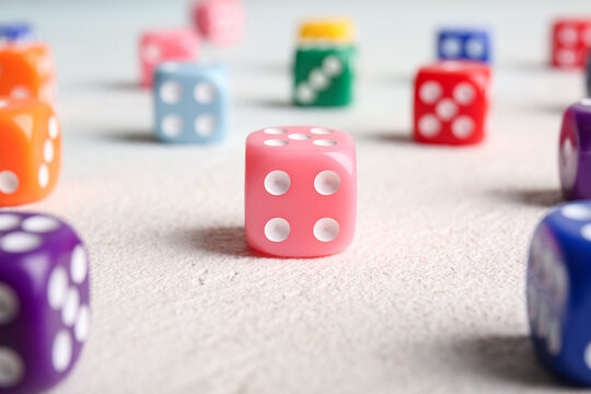 Many colorful dices on light background