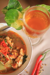 Bowl of Authentic Soto Ayam with Shredded Chicken and Aromatic Spices