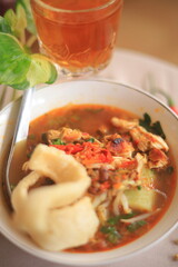 Bowl of Authentic Soto Ayam with Shredded Chicken and Aromatic Spices