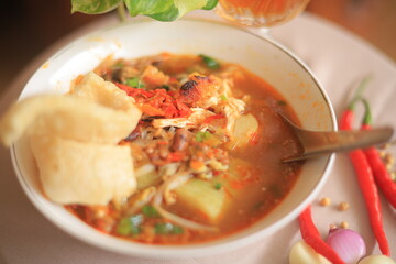 Bowl of Authentic Soto Ayam with Shredded Chicken and Aromatic Spices