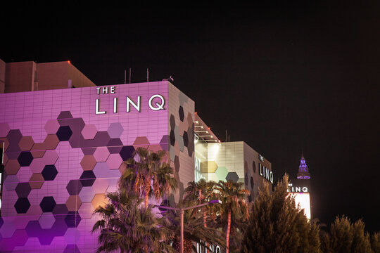 LAS VEGAS - AUGUST 22, 2024: The LINQ complex is shown at night with its hexagonal facade along the Strip. The Linq is a resort hotel and casino on the strip, part of Caesars Entertainment.